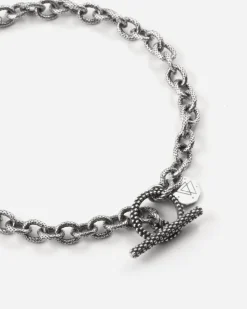 BRACCIALE CATENA RIGATA CON T-BAR PUNTINATA IN ARGENTO